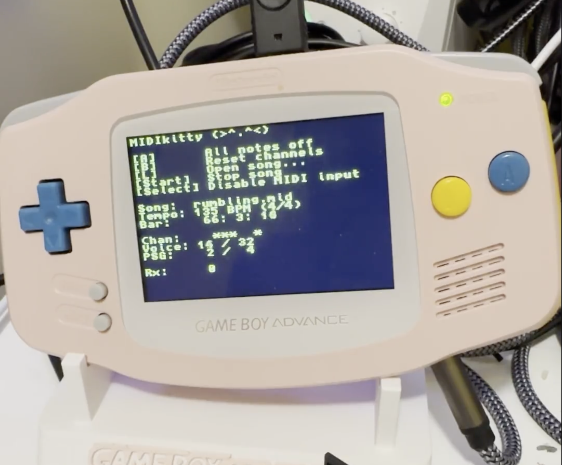 Picture of a GBA with the MIDIkitty interface on screen playing a file.